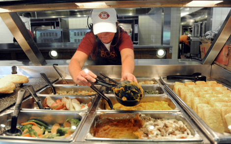 A Boston Market employee scoops some nasty goop into a bowl.